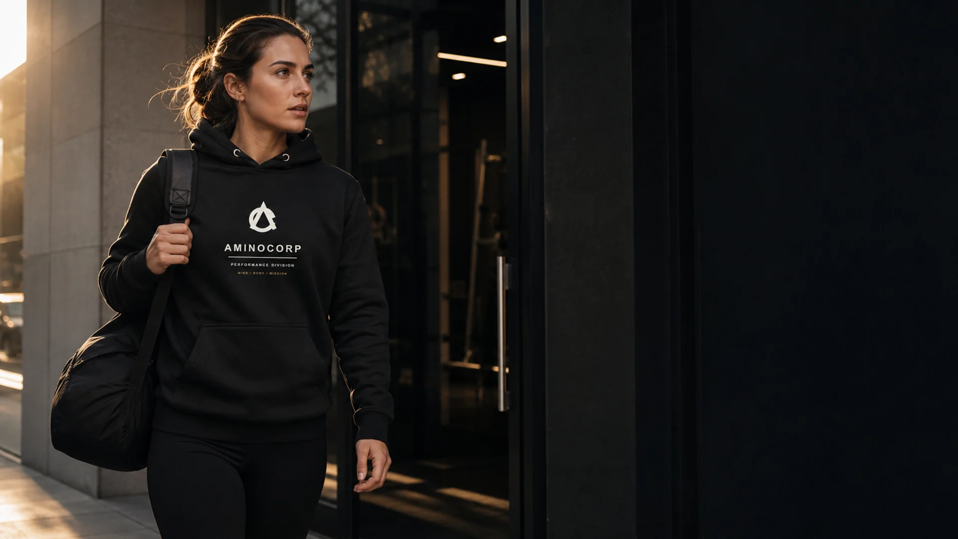 Entrepreneur-athlete wearing the black AminoCorp Performance Division Hoodie